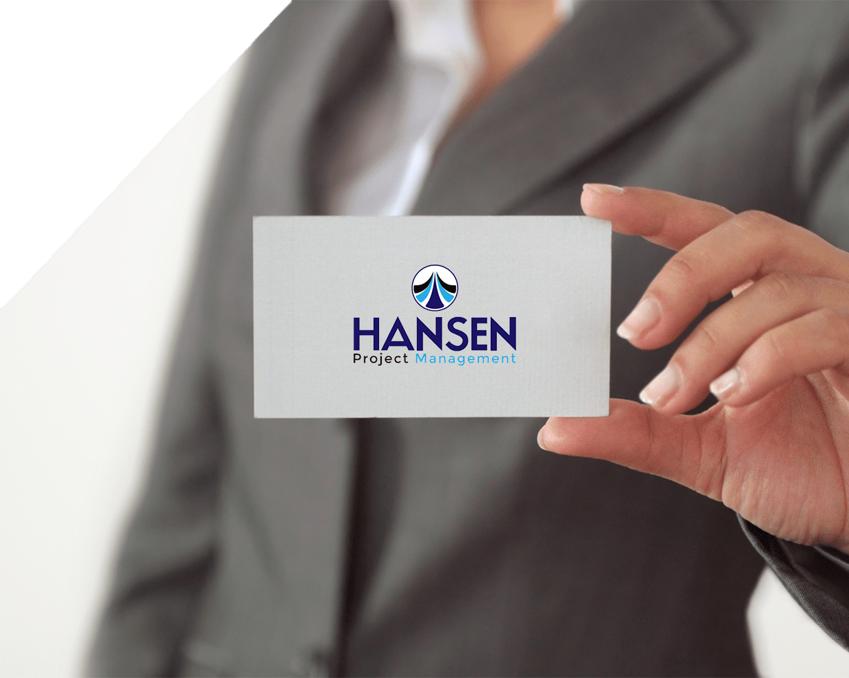 A woman displaying a business card featuring the Hansen logo, emphasizing professionalism and brand identity.